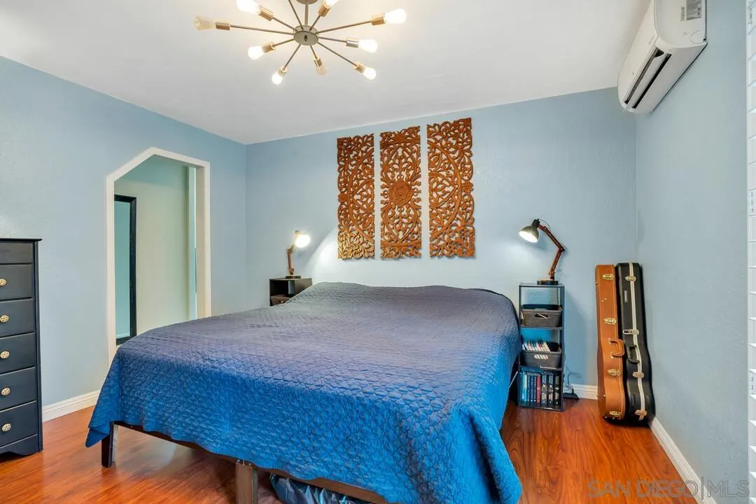 1635 Portola Avenue Spring Valley, CA 91977 - Photo 25 of 54 a bedroom with a bed and a chandelier