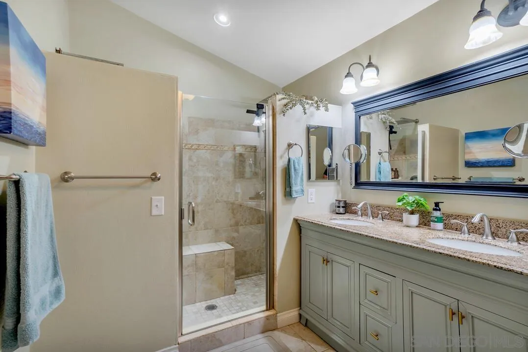 1635 Portola Avenue Spring Valley, CA 91977 - Photo 27 of 54 a bathroom with a shower sink and mirror