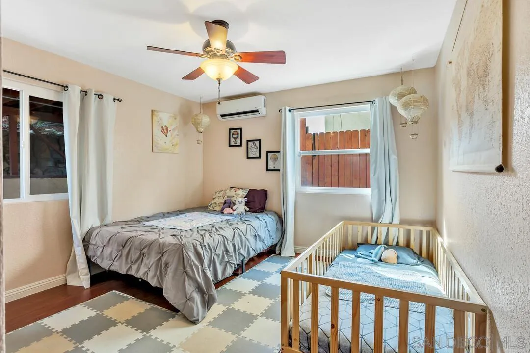 1635 Portola Avenue Spring Valley, CA 91977 - Photo 32 of 54 a bedroom with a bed and a table in it