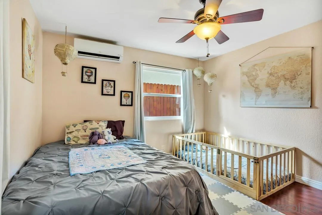 1635 Portola Avenue Spring Valley, CA 91977 - Photo 33 of 54 a bedroom with a bed and a chandelier