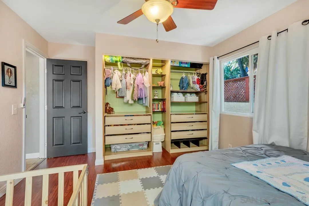 1635 Portola Avenue Spring Valley, CA 91977 - Photo 34 of 54 a bedroom with a bed and a chandelier