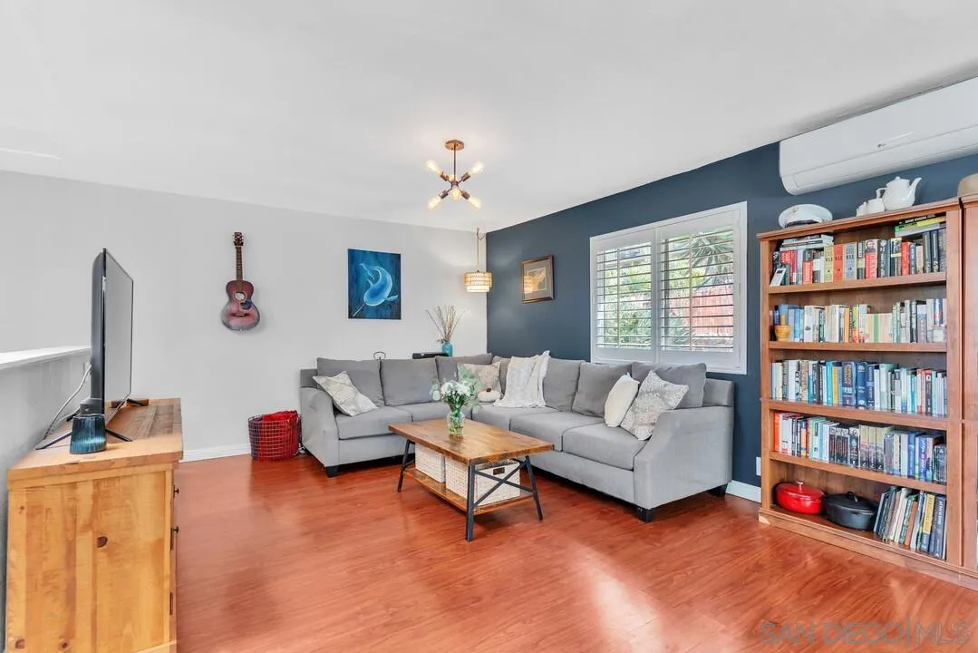 1635 Portola Avenue Spring Valley, CA 91977 - Photo 8 of 54 a living room with furniture and a book shelf