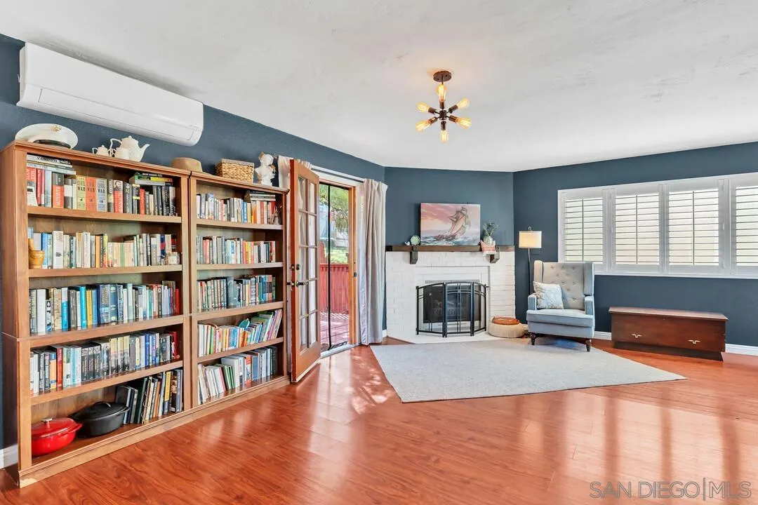 1635 Portola Avenue Spring Valley, CA 91977 - Photo 9 of 54 a living room with fireplace furniture and a book shelf