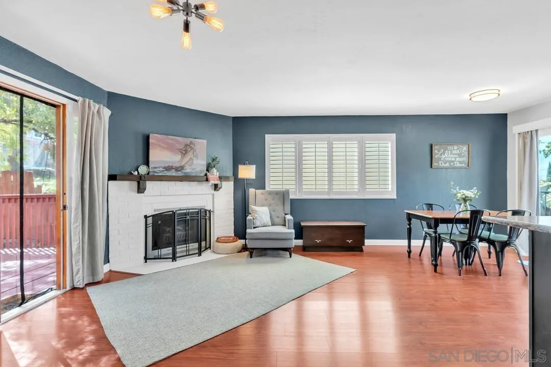 1635 Portola Avenue Spring Valley, CA 91977 - Photo 10 of 54 a living room with furniture a fireplace and a flat screen tv