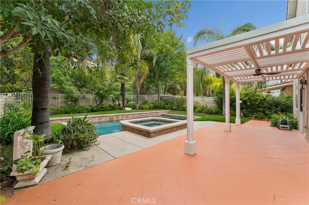 26023 Salinger Lane Stevenson Ranch, CA 91381 - Photo 26 of 35 Stunning backyard retreat complete with a sparkling pool, relaxing spa, lush palm trees, and fruit trees.