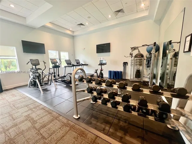 a living room with lots of furniture and gym equipment