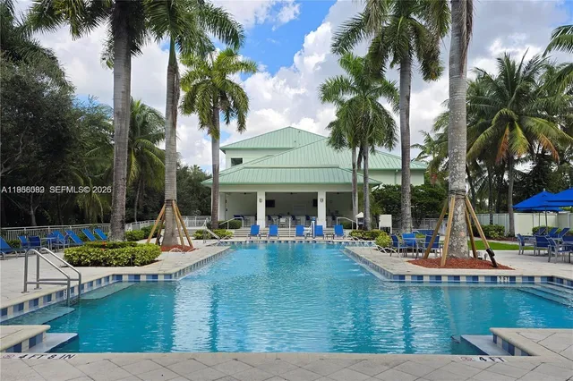 a view of an ocean with boats and palm trees
