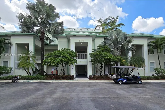 a view of a house with a cars park and palm trees