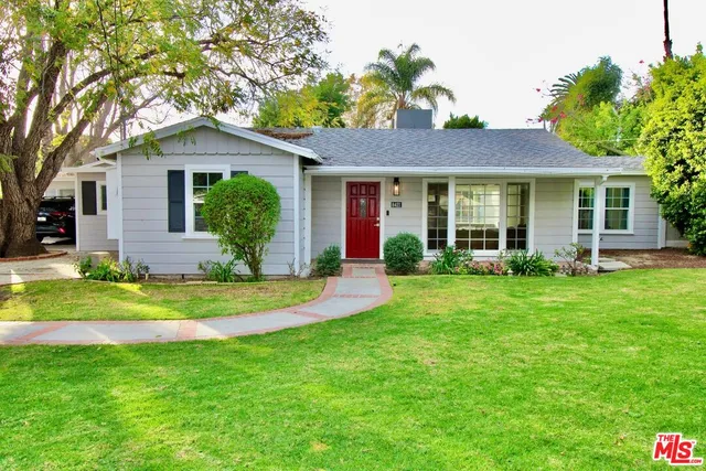 a front view of house with yard and green space
