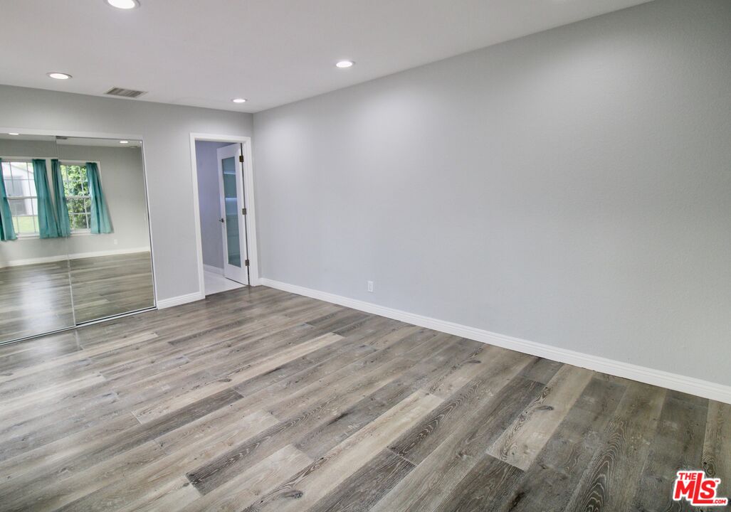 8421 Darby Avenue Northridge, CA 91325 - Photo 11 of 38 an empty room with wooden floor and entrance