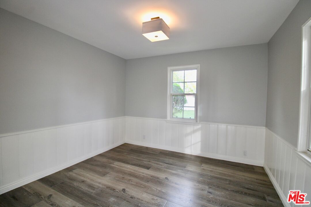 8421 Darby Avenue Northridge, CA 91325 - Photo 16 of 38 an empty room with wooden floor and windows