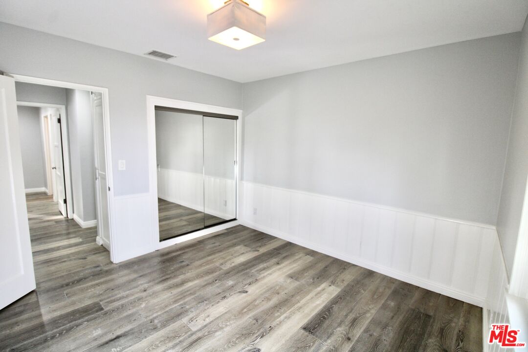 8421 Darby Avenue Northridge, CA 91325 - Photo 17 of 38 an empty room with wooden floor