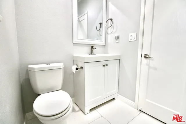 a white toilet sitting next to a bathroom sink