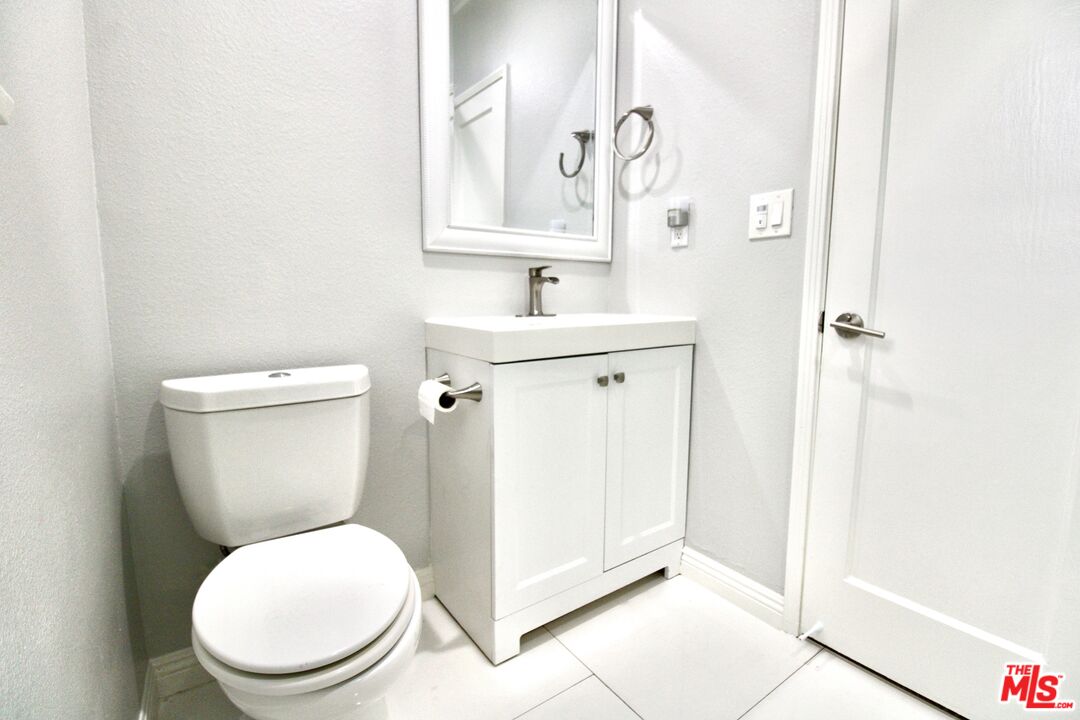 8421 Darby Avenue Northridge, CA 91325 - Photo 18 of 38 a white toilet sitting next to a bathroom sink