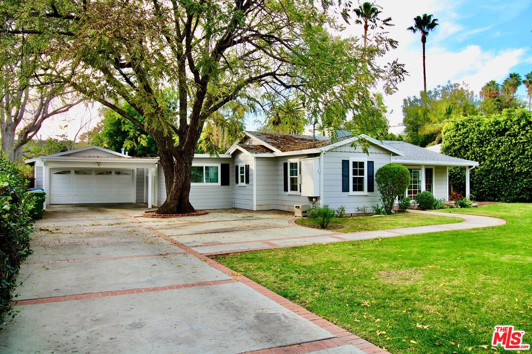 8421 Darby Avenue Northridge, CA 91325 - Photo 2 of 38 a front view of a house with yard and green space