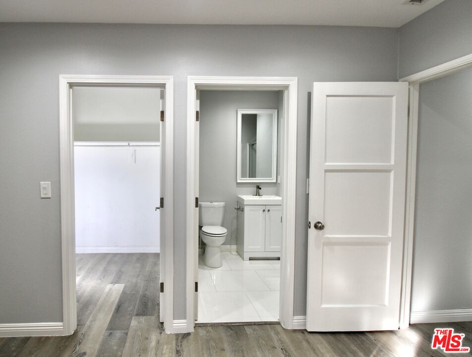 8421 Darby Avenue Northridge, CA 91325 - Photo 22 of 38 a view of a hallway with wooden floor