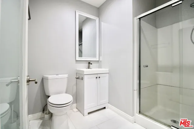 a bathroom with a toilet a sink and shower