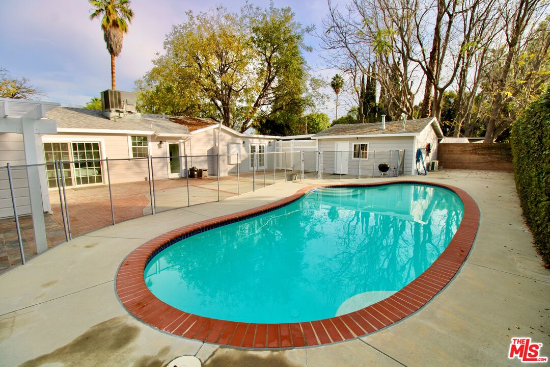 8421 Darby Avenue Northridge, CA 91325 - Photo 25 of 38 a view of a swimming pool with an outdoor seating
