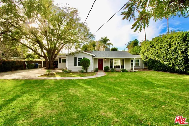a front view of a house with yard patio and green space