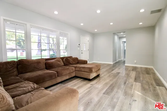 a living room with a couch and a dresser