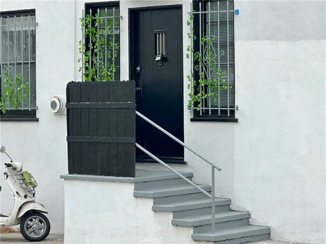 a view of entryway with wooden floor and front door