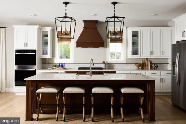 a kitchen with a sink a center island and cabinets