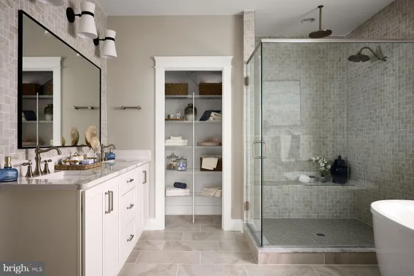 a bathroom with a double vanity sink toilet and shower