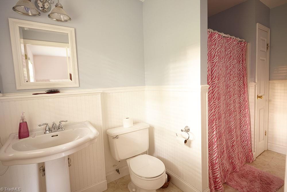 1729 Hauser Road Lewisville, NC 27023 - Photo 13 of 18 Private bath for the second bedroom. The bath is a full walk-in shower. Bead board and chair moulding are added finishes.