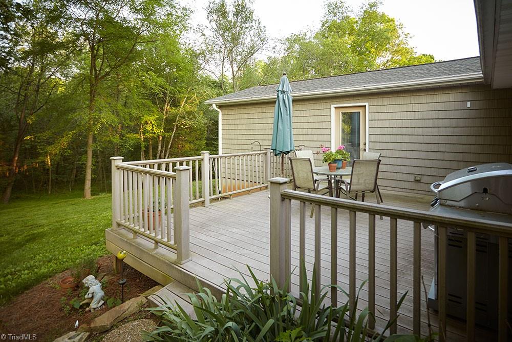 1729 Hauser Road Lewisville, NC 27023 - Photo 14 of 18 Relax on the composite decking, overlooking your wooded, private back yard.