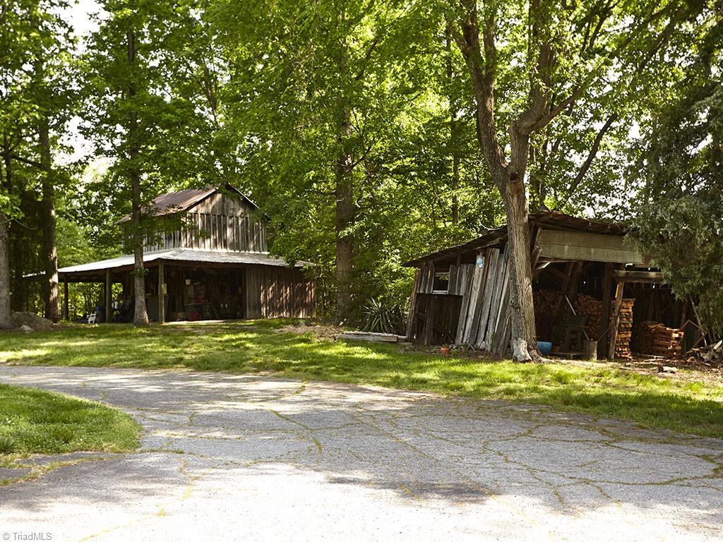 1729 Hauser Road Lewisville, NC 27023 - Photo 17 of 18 The tobacco barn (left) dates back to 1948. The current owners added the perimeter shed for additional storage. The shed (right) also offers more storage space.
