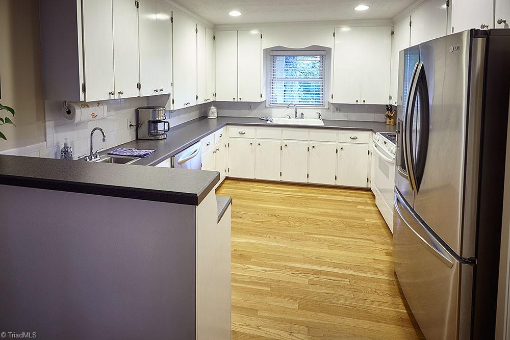 1729 Hauser Road Lewisville, NC 27023 - Photo 4 of 18 Clean, sleek lines and plenty of counter and storage space make this kitchen functional and beautiful. A second sink adds convenience for additional prep work.