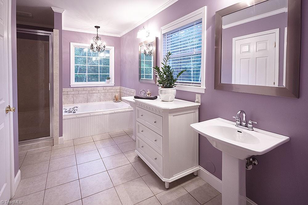 1729 Hauser Road Lewisville, NC 27023 - Photo 10 of 18 The design and functionality of the owner's bath will give you the feeling of a spa-like escape. Jetted tub, over-size shower, linen closet and separate vanities create comfort and convenience.