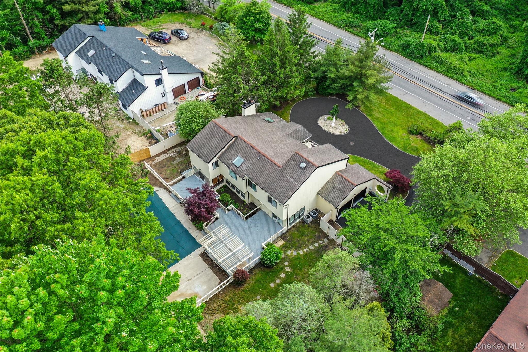 126 Bagatelle Road Melville, NY 11747 - Photo 6 of 50 an aerial view of residential house with outdoor space and trees all around