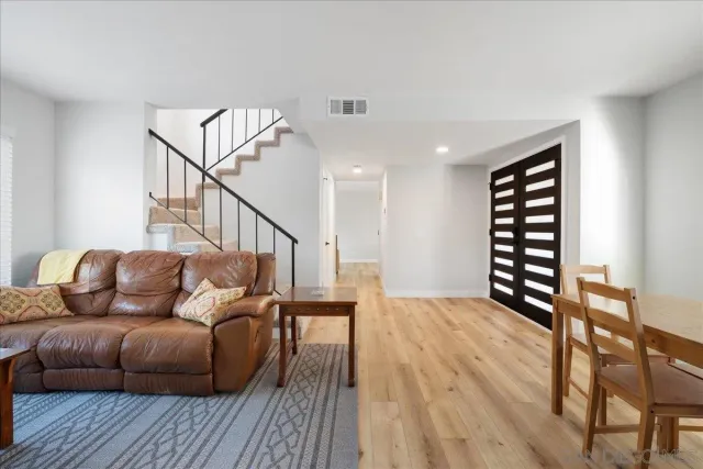 a living room with furniture and wooden floor