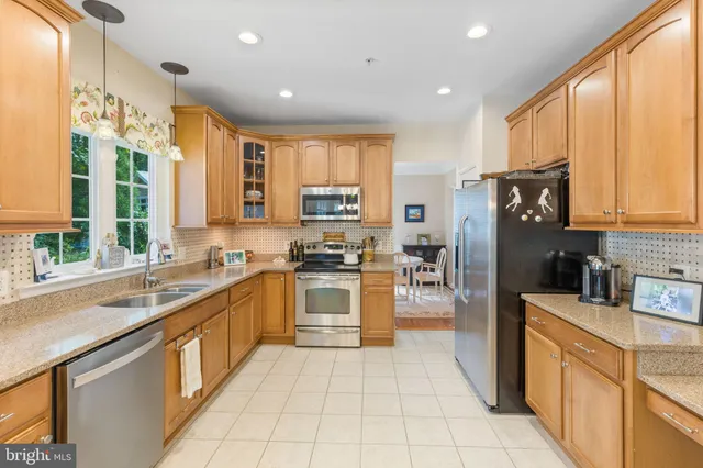 a kitchen with stainless steel appliances a refrigerator sink and cabinets