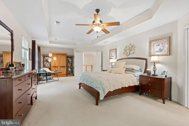 a spacious bedroom with a bed and window