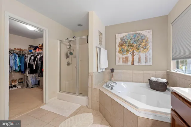 a spacious bathroom with a tub and shower
