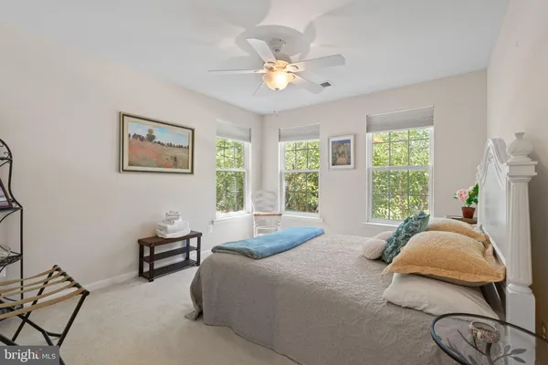 a bedroom with a bed a chandelier and a window