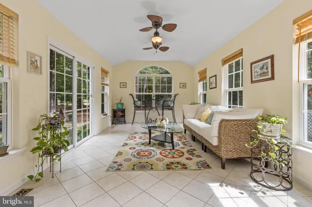 a living room with furniture chandelier and a window