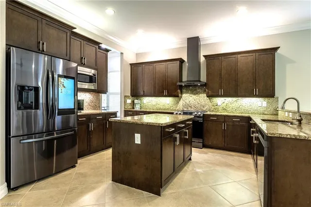 a large kitchen with a counter space a sink stainless steel appliances and cabinets