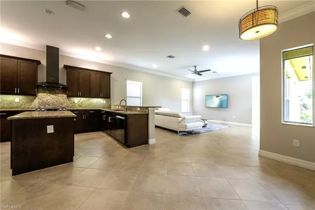a kitchen with a chandelier and a counter top space