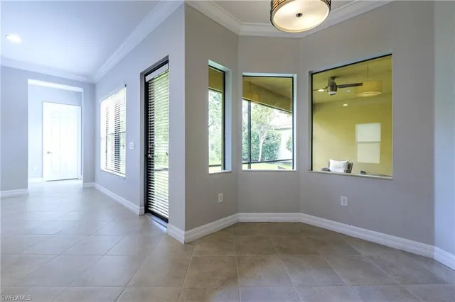 a bed sitting in a spacious bedroom next to a window