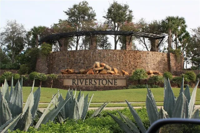 an aerial view of a house with a lake