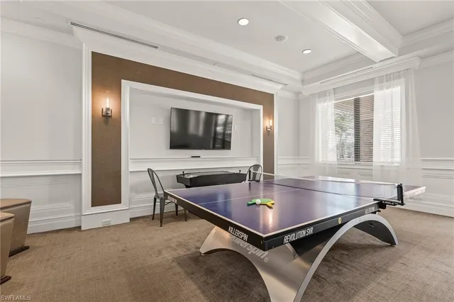 a living room with furniture a table and a chandelier