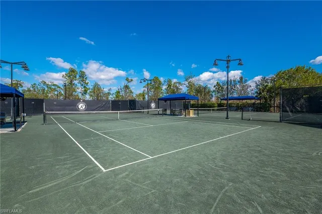 a view of a patio with a table and chairs under an umbrella