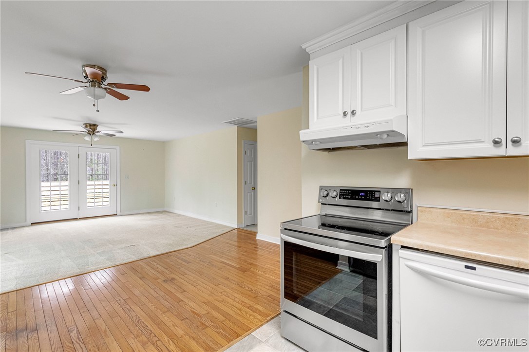 20275 Ben Gayle Road Beaverdam, VA 23015 - Photo 6 of 49 a kitchen with granite countertop a stove a sink and dishwasher with white cabinets