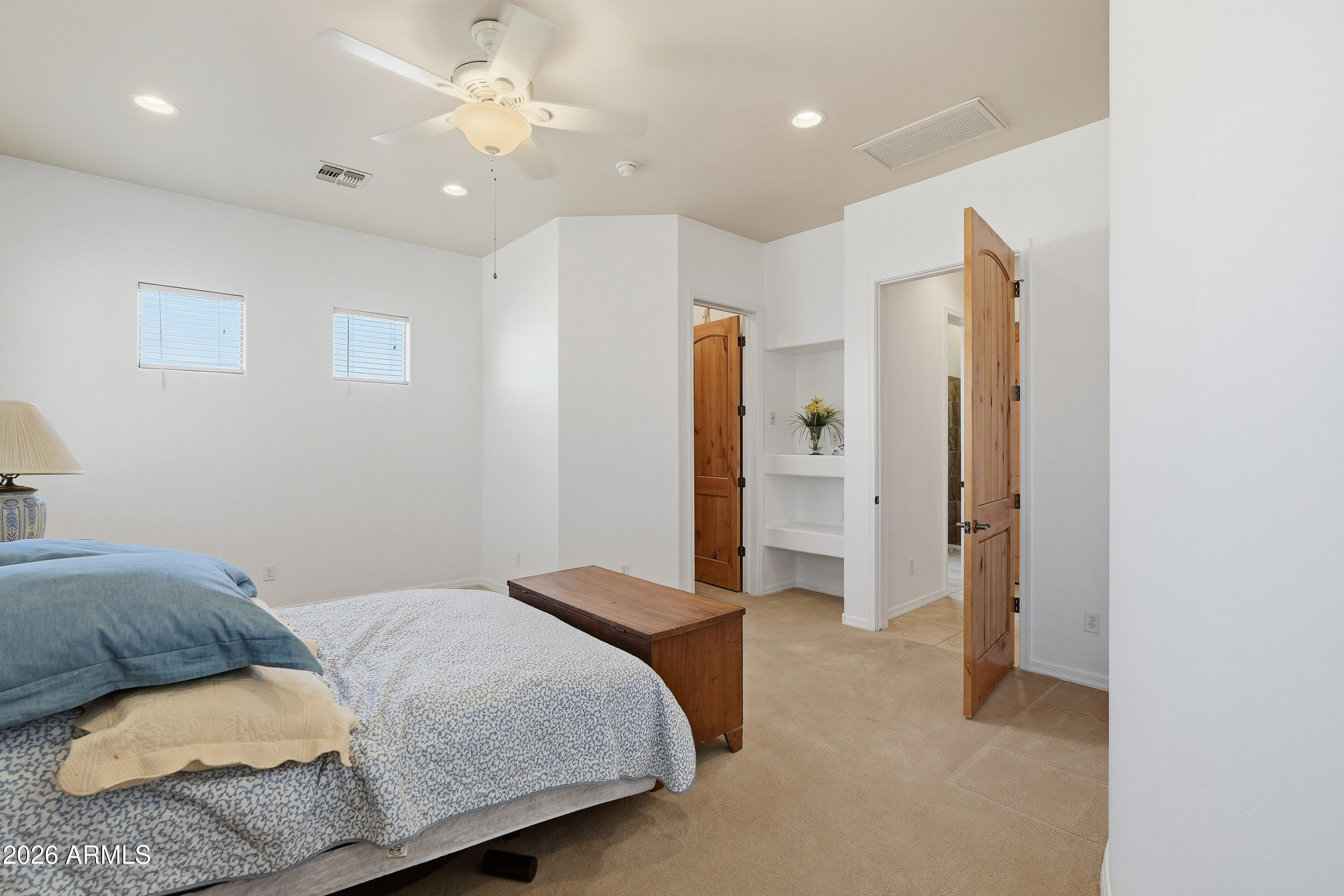 2616 West Canyon Road Phoenix, AZ 85086 - Photo 39 of 45 a bedroom with a bed and a chandelier