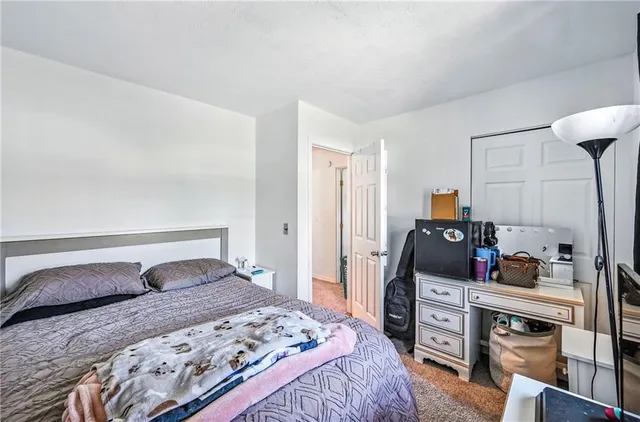 a bedroom with a bed and dresser