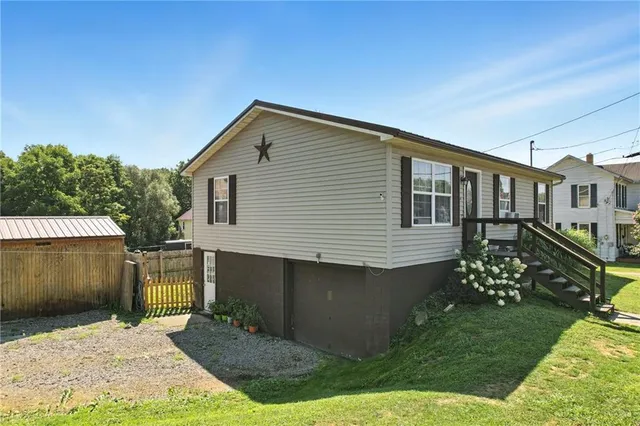 a front view of a house with a garden