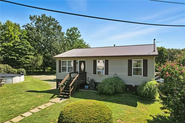 a view of a house with backyard sitting area and garden